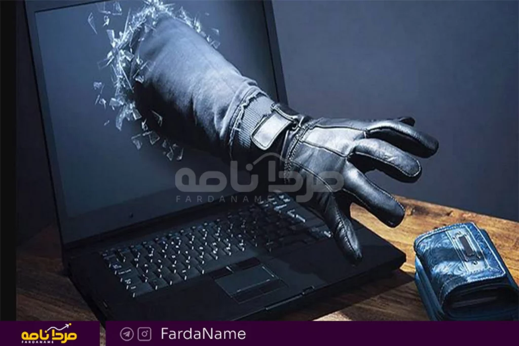 دست خارج شده از صفحه لپ‌تاپ در حال تلاش برای سرقت کیف پول و دارایی